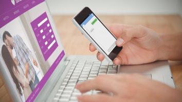 Online dating app against man holding mobile phone while typing on laptop at desk,Image: 279955971, License: Royalty-free, Restrictions: , Model Release: yes