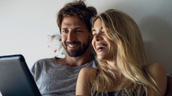 Happy young couple watching movie on digital tablet in bedroom,Image: 499136627, License: Royalty-free, Restrictions: , Model Release: no