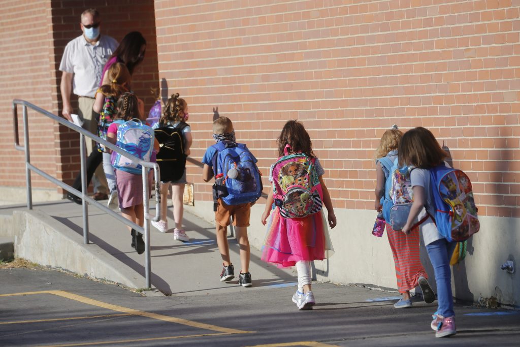 școlari mergând pe trotuar