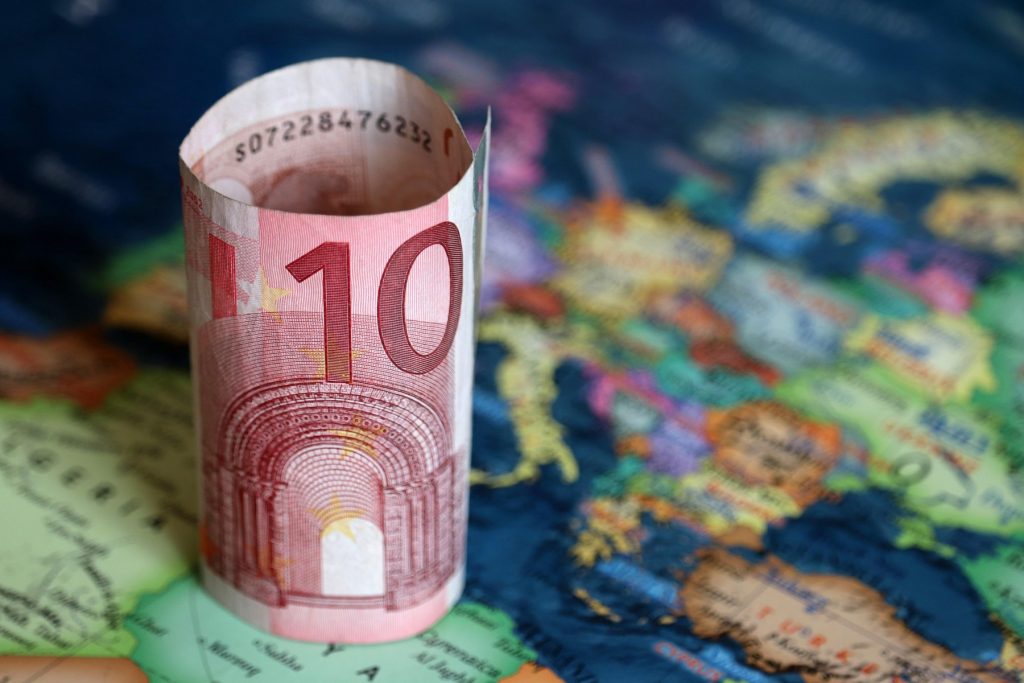Euro banknote on the Europe map. Concept of Eurozone, European economy, stock market and trading in EU