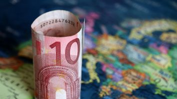 Euro banknote on the Europe map. Concept of Eurozone, European economy, stock market and trading in EU