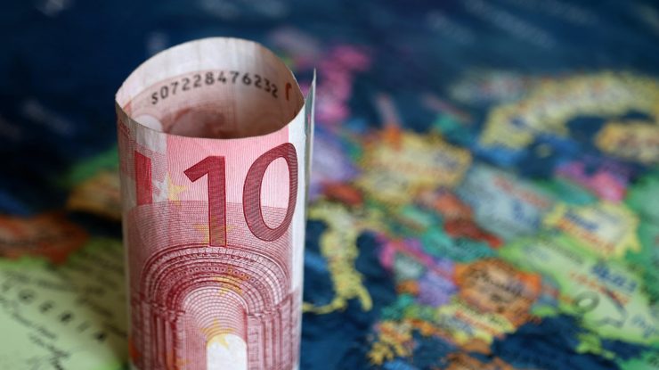 Euro banknote on the Europe map. Concept of Eurozone, European economy, stock market and trading in EU