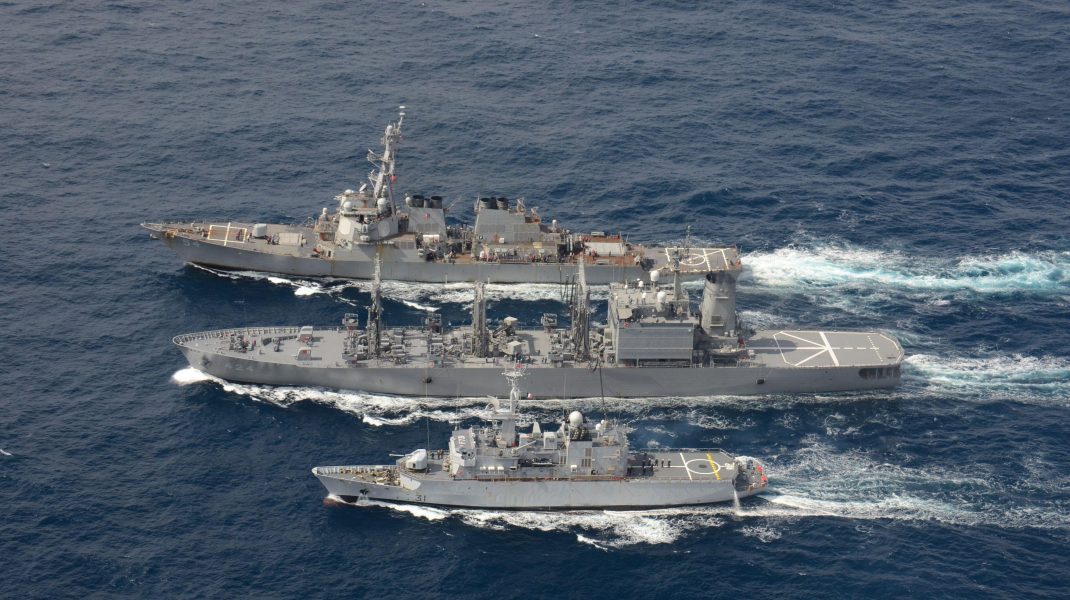 The U.S. Navy Arleigh Burke-class guided-missile destroyer USS Curtis Wilbur, top, conducts a replenishment-at-sea with the Japan Maritime Self-Defense Force Towada-class replenishment ship JS Hamana, center, and French Floreal-class light frigate FNS Pra