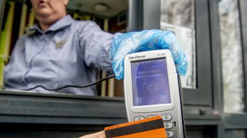 Bărbat care plătește cu cardul bancar la POS.