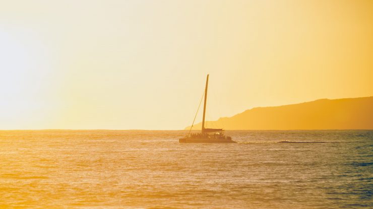 Vapor care merge pe apă la apus de soare.