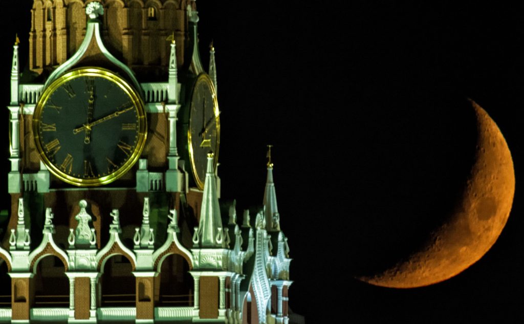 2823090 12.04.2016 The Moon over the Moscow Kremlin's Spasskaya (Savior) Tower. Vladimir Sergeev / Sputnik