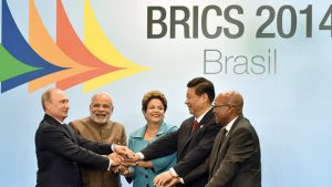 (L to R) Russia's President Vladimir Putin, India's Prime Minister Narendra Modi, Brazilian President Dilma Rousseff, China's President Xi Jinping and South Africa's President Jacob Zuma join their hands during the official photograph of the 6th BRICS summit in Fortaleza, Brazil, on July 15, 2014. Leaders of the BRICS (Brazil, Russia, India, China and South Africa) group of emerging powers gathered in Brazil on Tuesday to launch a new development bank and a reserve fund seen as counterweights to Western-led financial institutions. AFP PHOTO / NELSON ALMEIDA