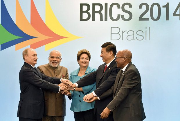 (L to R) Russia's President Vladimir Putin, India's Prime Minister Narendra Modi, Brazilian President Dilma Rousseff, China's President Xi Jinping and South Africa's President Jacob Zuma join their hands during the official photograph of the 6th BRICS summit in Fortaleza, Brazil, on July 15, 2014. Leaders of the BRICS (Brazil, Russia, India, China and South Africa) group of emerging powers gathered in Brazil on Tuesday to launch a new development bank and a reserve fund seen as counterweights to Western-led financial institutions. AFP PHOTO / NELSON ALMEIDA