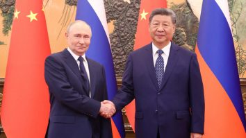 Chinese President Xi Jinping shakes hands with Russian President Vladimir Putin at the Great Hall of the People, in Beijing