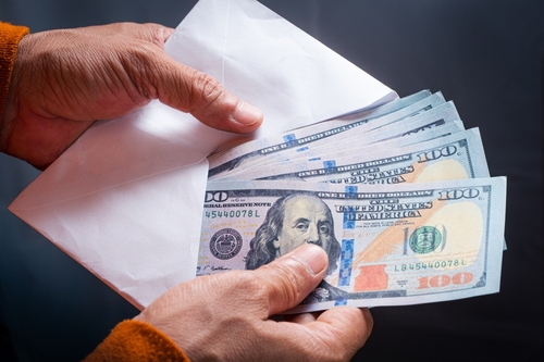 Man,Recounts,Us,Dollar,Banknote,From,White,Envelope.